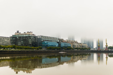 Fototapeta na wymiar Buenos Aires on a gray rainy day, skyscrapers of Puerto Madero neighborhood covered in mist
