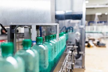 Water bottling line for processing and bottling pure mineral carbonated water into bottles. Selective focus.