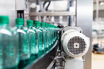 Water bottling line for processing and bottling pure mineral carbonated water into bottles. Selective focus.