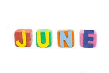 word June by wooden letter on clay