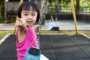Asian little Chinese girl playing swing