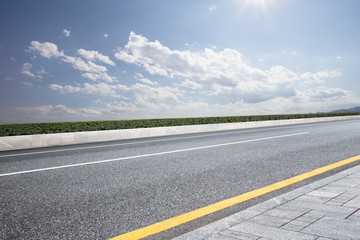 Fototapeta premium empty rural asphalt road in sunny day
