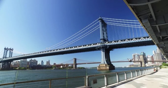 A daytime establishing shot of the Manhattan Bridge over the East River between Manhattan and Brooklyn.	 	