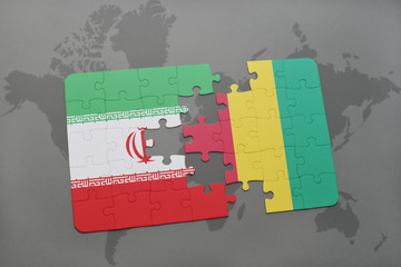 puzzle with the national flag of iran and guinea on a world map background.