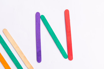 colorful of Ice cream sticks with word N on white background