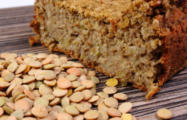 Heap of lentil and homemade pie on wooden background