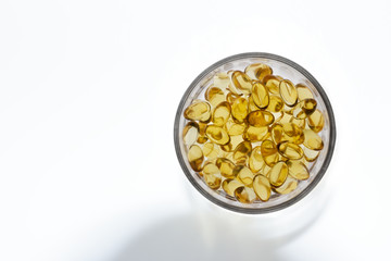 Cod liver oil gel capsules on white background.