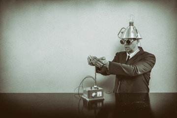 Businessman sitting at office desk with machine