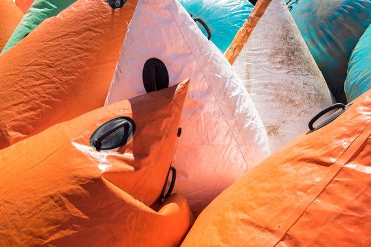 Pile of colorful inflatable buoys or floats. Used as markers and navigation devices in water