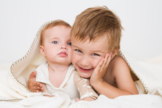 portrait of little boy with newborn sister, family concept

