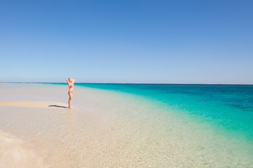 Fototapeta na wymiar Blonde woman posing paradise beach
