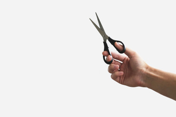 Scissors in hand. Isolated on grey background