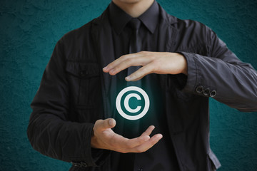 Man holding copyright symbol. Concept image for illustration of