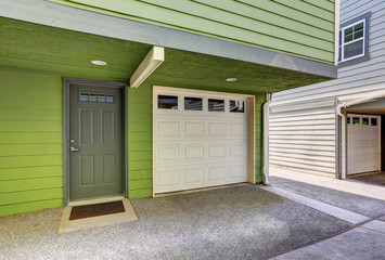 Small entrance porch and garage door of duplex house.