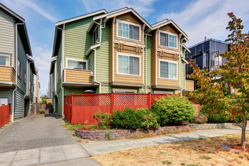 Fototapeta na wymiar American duplex house for two families. Green exterior paint