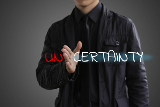 The concept of certainty. Businessman making certainty from unce
