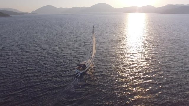 Boat sailing into the sun in Mediterranean Sea Aerial