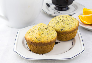 Orange poppy seed muffins on white plate