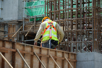 MALACCA, MALAYSIA -MARCH 29, 2016: Construction workers fabricating steel reinforcement bar at the...