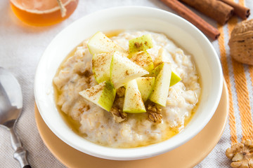 oatmeal porridge with apples, honey, nuts and cinnamon