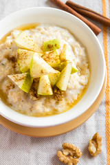 oatmeal porridge with apples, honey, nuts and cinnamon