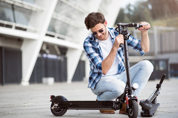 Pleasant delighted man holding kick scooter © zinkevych
