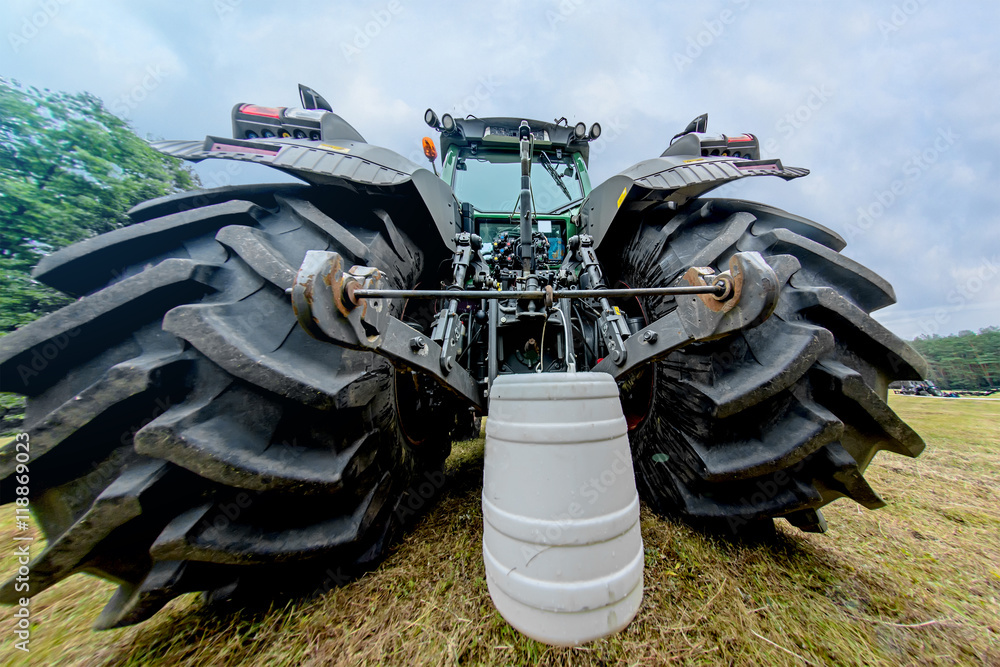 Poster Detail of a large tractor wheels with hanging bucket. Toning