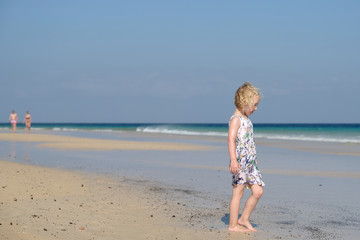 Fototapeta na wymiar kleines mädchen steht am strand
