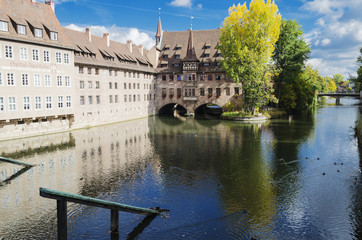 Naklejka premium Heilig-Geist-Spital or Hospital of the Holy Spirit, over the river Pegniz in Nuremberg, Germany