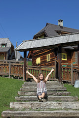 happy little girl with thumbs up countryside vacation