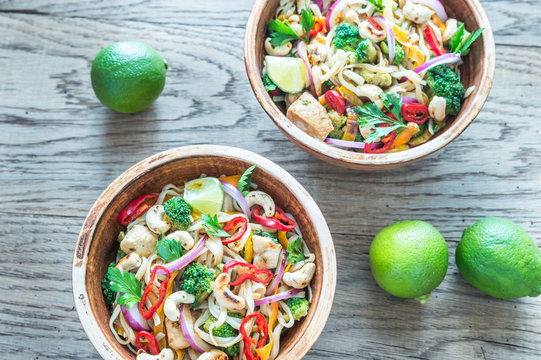 Two bowls of chicken noodle stir-fry