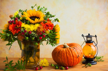 Naklejka na ściany i meble Autumn flowers and pumpkin