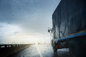 Bad weather conditions on the road during rain storm ,view through the wind shield of rainy day.Selective focus and color toned.