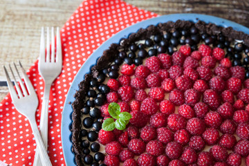 Homemade tart pie with cream, raspberry and black currants