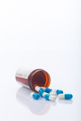 white and blue capsules,medical concept