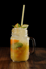 orange, lemon and lime mix. fresh cocktail. citrus juice. black background