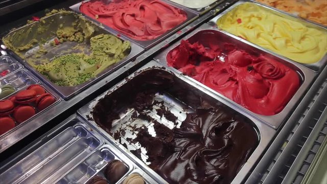 Ice cream assortment on street shop. Gelato - Italian frozen dessert, delicious sorbets with various fruits flavors. Summer refreshing snack. Real time and copy space.