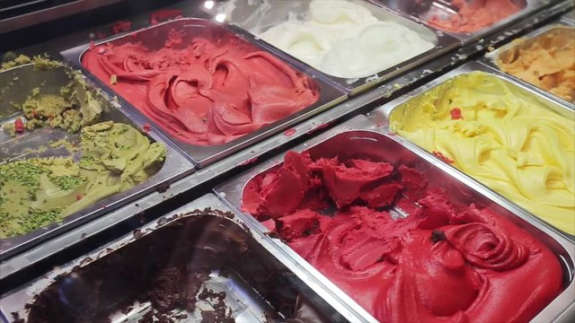 Ice cream assortment on street shop. Gelato - Italian frozen dessert, delicious sorbets with various fruits flavors. Summer refreshing snack. Real time and copy space.