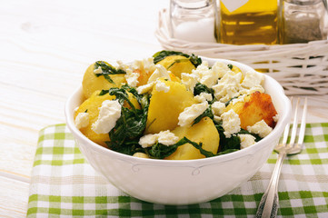 Salad with roasted potatoes , spinach and feta.