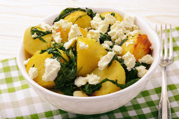 Salad with roasted potatoes , spinach and feta.