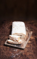Fresh bread on wooden background. White baked bread on a wooden