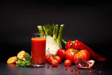 Tomato juice in a glass jar on a black table