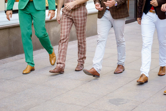 Group Of Stylish Men Walking Down The Street