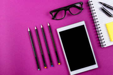 Office supplies on purple background