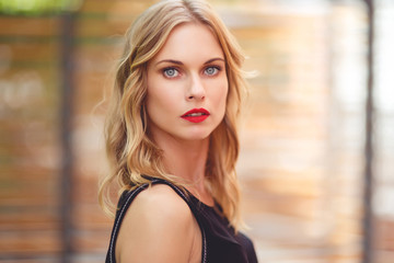 Beautiful girl with curly blond hair and red lipstick
