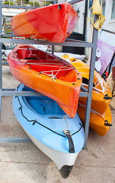 Plastic kayaks on the rack in the port