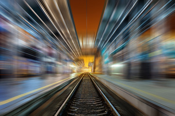Fototapeta na wymiar Railway station at night with motion blur effect. Railroad