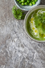 Pea soup puree in an old plate with parsley decoration. Stone sl