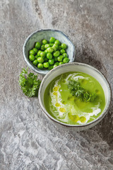 Pea soup puree in an old plate with parsley decoration. Stone sl