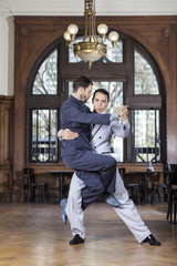 Confident Tango Dancer Lifting Male Partner - obrazy, fototapety, plakaty